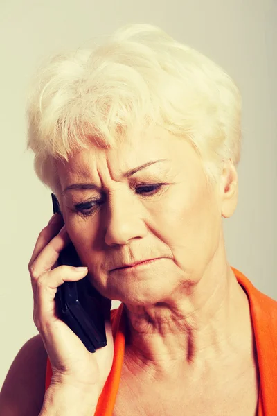An old lady talking through phone. — Stock Photo, Image