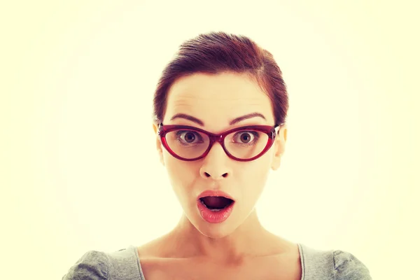 Young casual woman in eyeglasses expresses shock. Stock Image
