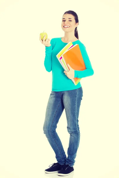 Mooie jonge student met bestanden en apple. — Stockfoto