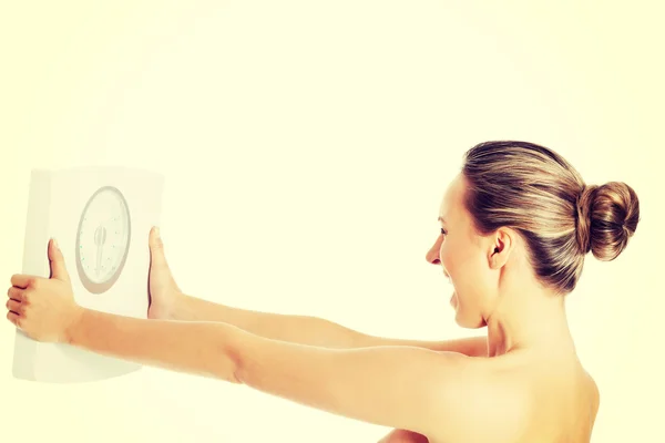 Nude topless woman holding scale. — Stockfoto