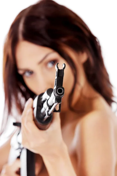 Sexy nude brunette girl model with weapon. — Stock Photo, Image