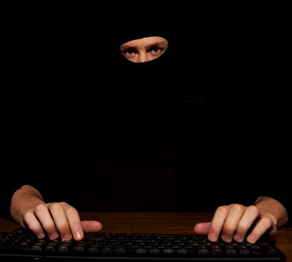 Dangerous hacker in black balaclava — Stock Photo, Image