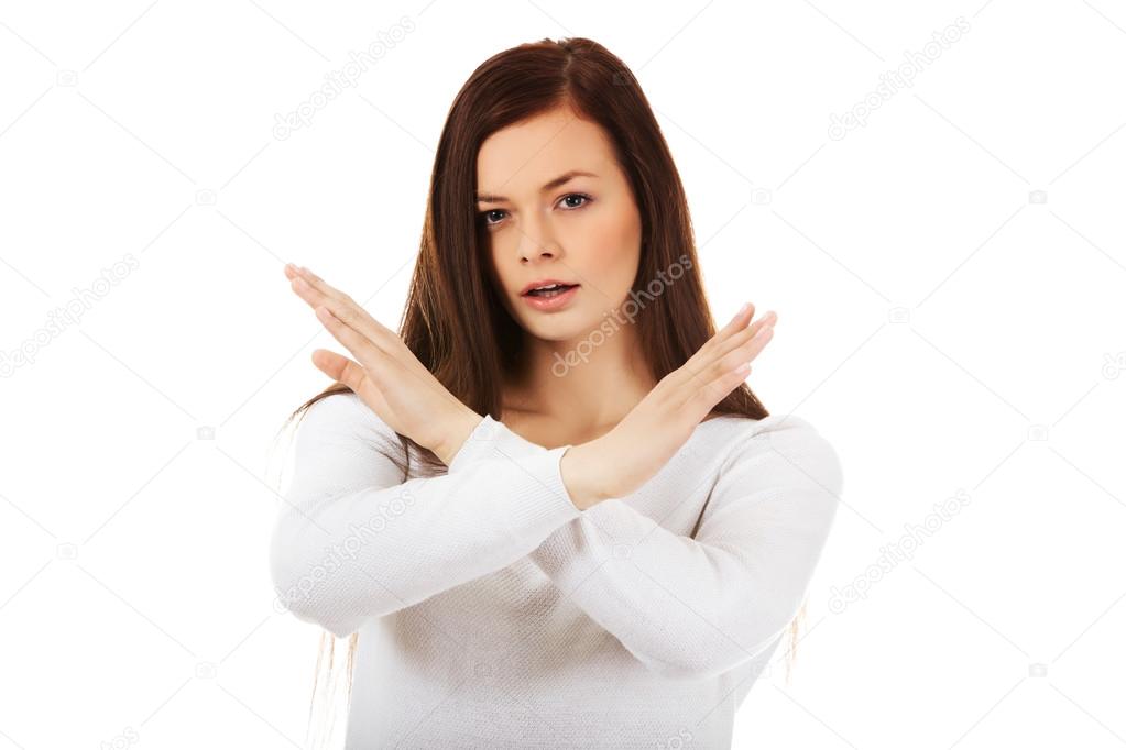 Young angry screaming woman gesturing stop sign