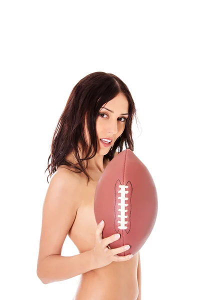 Mooi naakt vrouw holding amerikaans voetbal bal. — Stockfoto