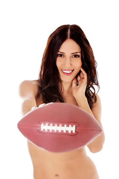 Beautiful nude woman holding american football ball. — Stock Photo, Image