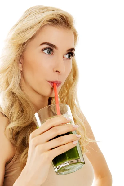 Junge Frau trinkt grünen Cocktail — Stockfoto
