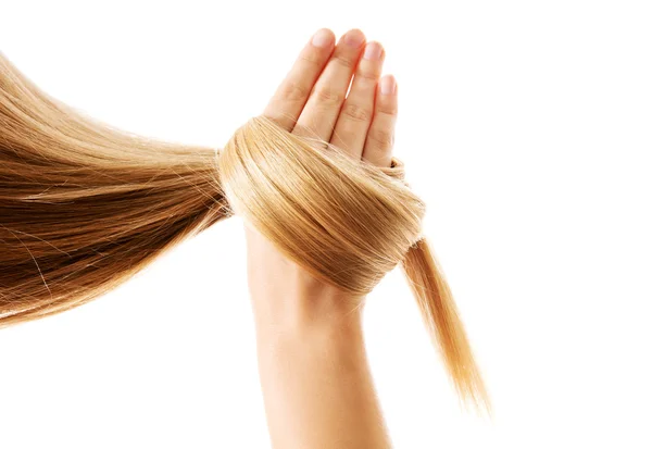 Cabelo na mão. Isolado em branco. — Fotografia de Stock