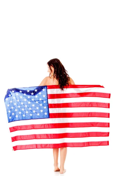 Beautiful brunette woman wrapped into American flag. Stock Photo