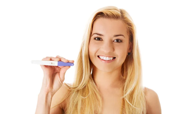 Excited young woman holding positive pregnancy test. Isolated on white. — Stock Photo, Image