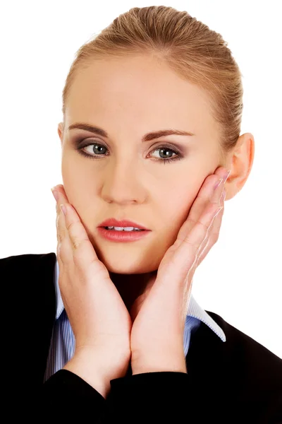 Young worried business woman with hands on cheeks — Stock Photo, Image