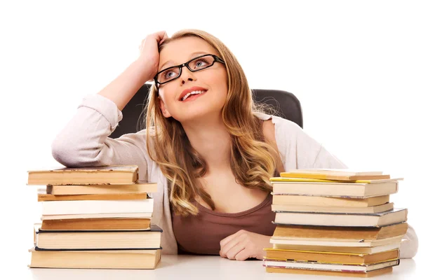 Mujer joven con una pila de libros — Foto de Stock