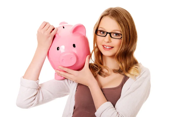 Joven mujer holding piggybank —  Fotos de Stock