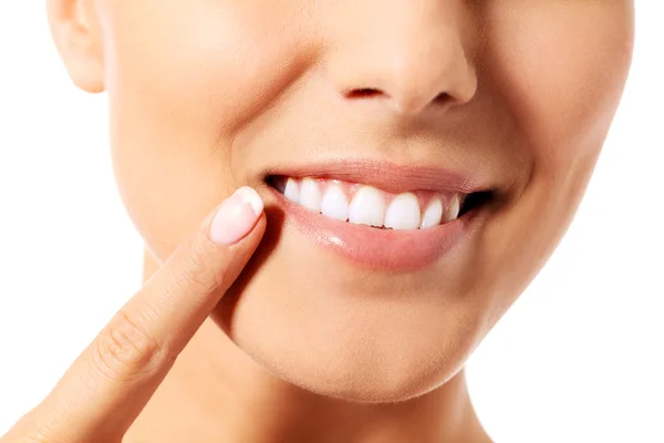 Dental health concept - beautiful woman pointing to her teeth — Stock Photo, Image