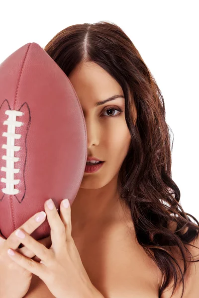 Mooi naakt vrouw holding amerikaans voetbal bal. — Stockfoto