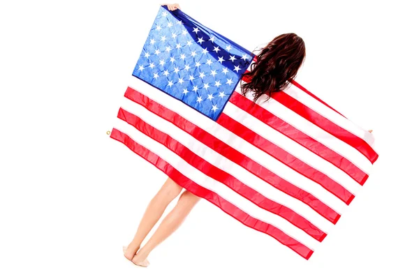 Schöne brünette Frau in amerikanische Flagge gehüllt. — Stockfoto
