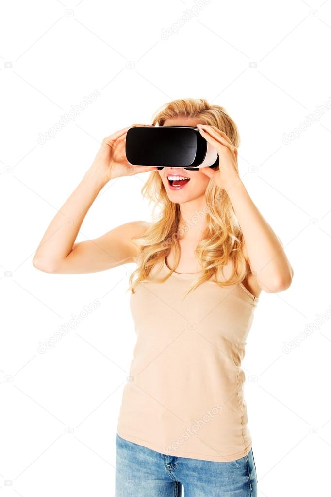 Happy woman wearing virtual reality goggles