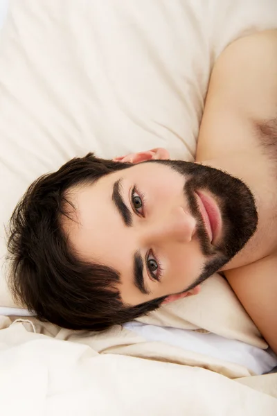 Joven musculoso acostado en la cama. —  Fotos de Stock