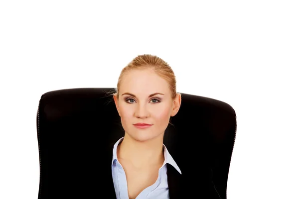 Молода усмішка бізнес-леді сидить на стільці в офісі — стокове фото