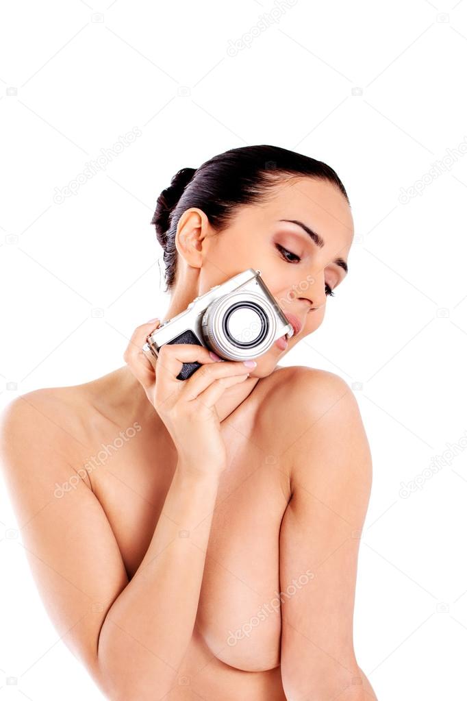 Nude beautiful woman with photo camera.