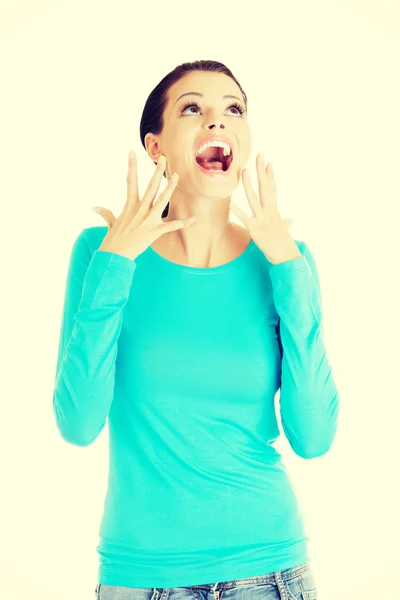 Beautiful casual woman screaming, looking up. — Stock Photo, Image