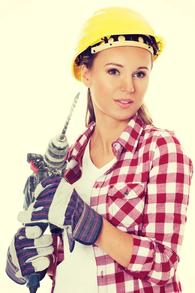 Mujer joven en casco protector y martillo neumático . — Foto de Stock