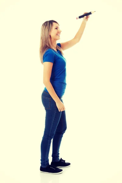 Young casual woman writing on copy space. — Stock Photo, Image