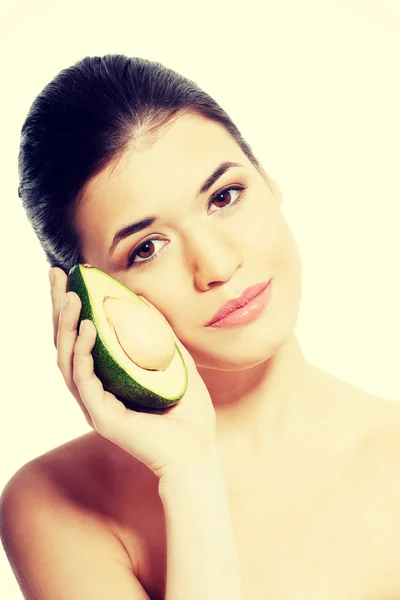 Beautiful woman holding avocado. — Stock Photo, Image