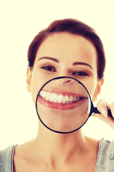 Young beautiful woman with magnifying glass. — Stock Photo, Image