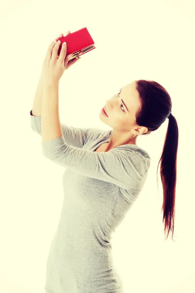 Beautiful young woma checking her empty wallet. — Stock Photo, Image