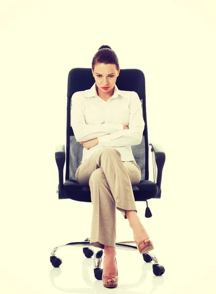 Young sad business woman sitting on a chair. — Stock Photo, Image