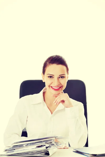 Beautiful business woman sitting by a desk. — Stock Photo, Image