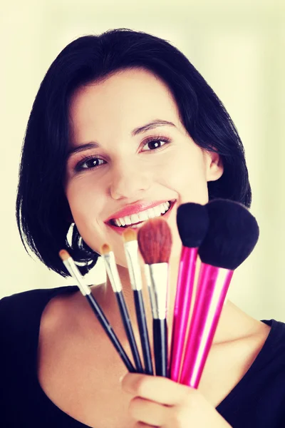 Young make-up artist woman holding brushes — Stock Photo, Image