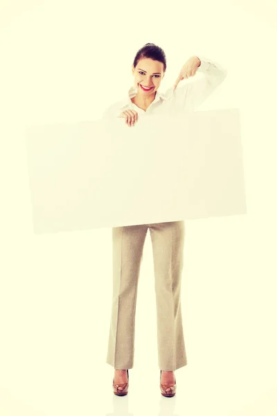 Beautiful business woman pointing on copy space. Royalty Free Stock Images