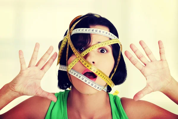 Woman with measuring tape around her head — Stock Photo, Image