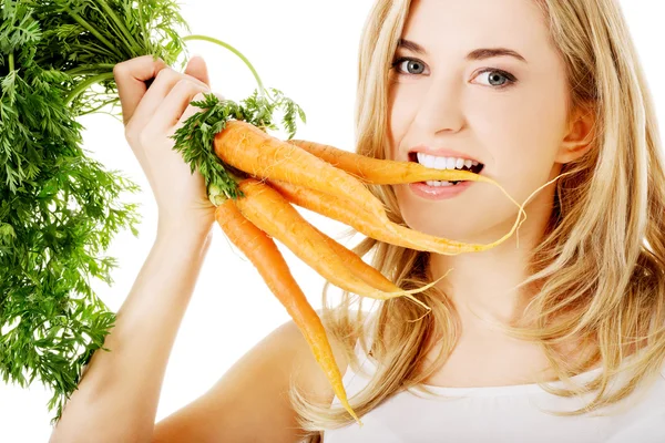 Young woman with the carrots — Stock Photo, Image