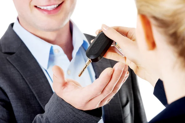 Car salesman handing over the keys — Stock Photo, Image