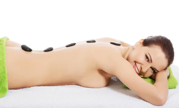 Girl on a stone therapy, hot stone massage — Stock Photo, Image