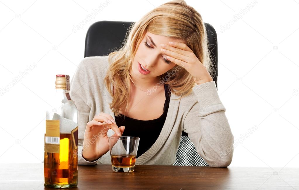 Yound woman in depression, drinking alcohol