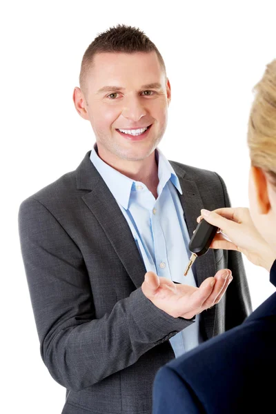 Car salesman handing over the keys — Stock Photo, Image