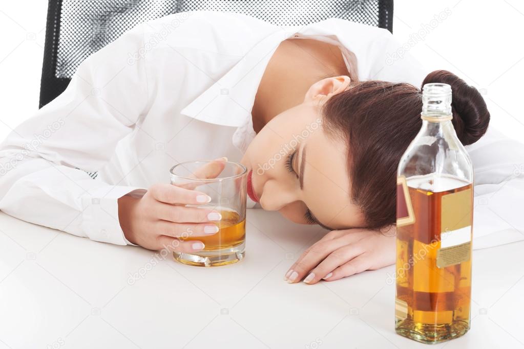 Alone young businesswoman drinking alcohol