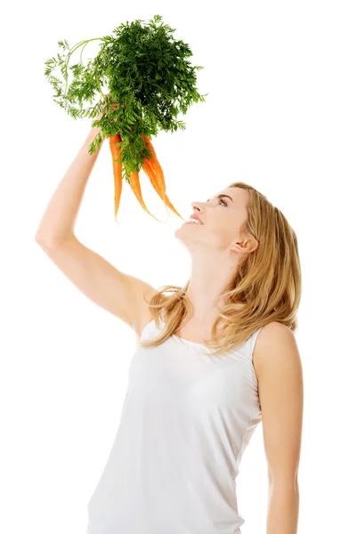 Young woman with the carrots — Stock Photo, Image