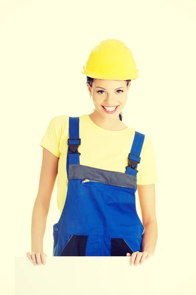 Female construction worker with blank board — Stock Photo, Image