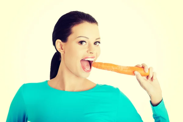 Happy beautiful woman with carrot Stock Picture