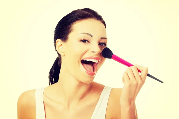 Attractive woman doing make-up on face. — Stock Photo, Image