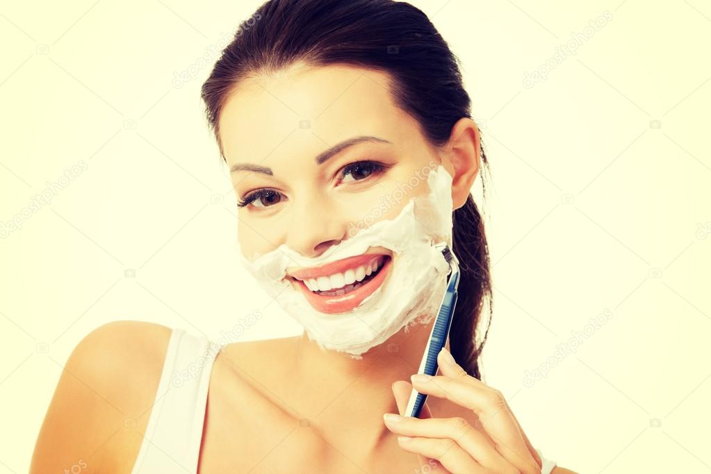 Beautiful woman shaving her face with a razor — Stock Photo © piotr