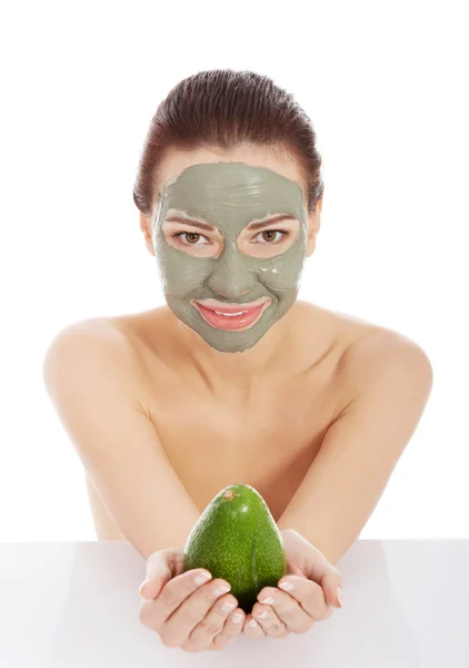 Hermosa mujer spa en máscara facial y aguacate —  Fotos de Stock