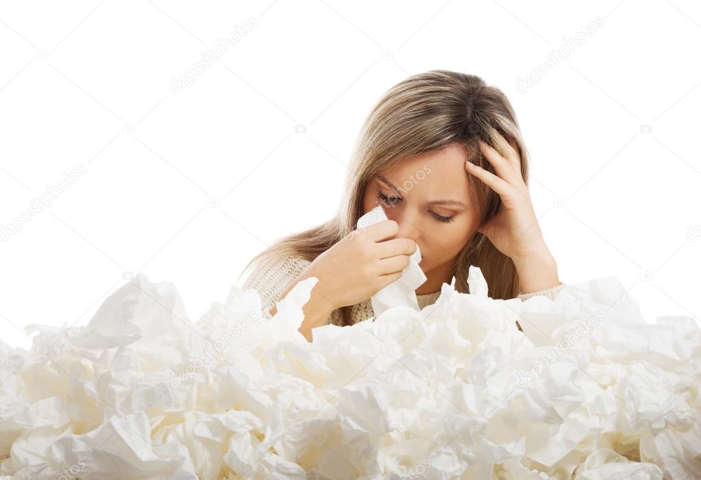 Young woman in lot of tissues around