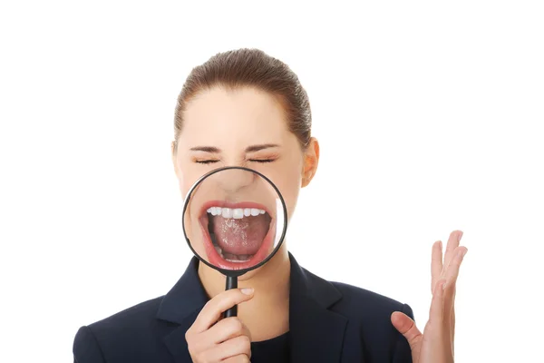 Business woman looking into a magnifying glass — Stock Photo, Image