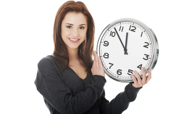 Happy woman holding office clock Stock Picture