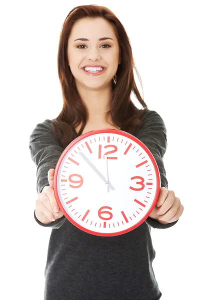 Happy woman holding office clock Stock Image